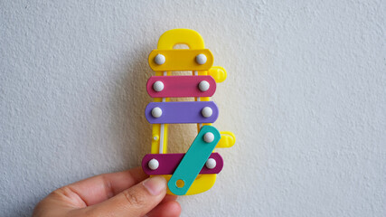 hand holding colorful plastic toy blocks