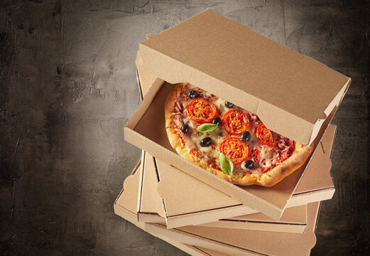 Stacked generic boxes with fresh pizza inside