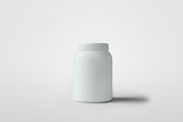 Mockup of a small jar with a lid for a healthy organic product or vitamins, a bottle for advertising in pharmacy or medicine.