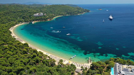 Obraz premium Aerial drone photo of beautiful popular organised sandy bay, turquoise beach and natural preserve lake with pine trees of Koukounaries, Skiathos island, Sporades, Greece
