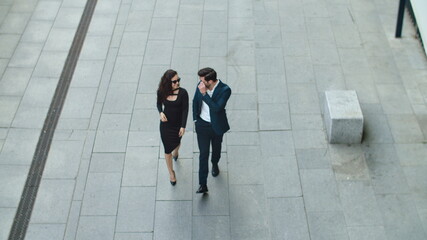 Top view cheerful couple walking at street. Business couple smiling outdoors