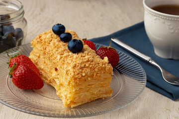 Piece of russian honey cake medovik served with berries