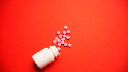 Spilled pills or tablets as pattern from a plastic drugs bottle