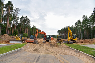 Bulldozer, Excavator and Soil compactor on road work. Earth-moving heavy equipment and Construction machinery  during land clearing, grading, pool excavation, utility trenching and digging