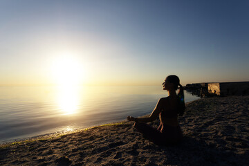 Woman sitting in lotus pose and meditating