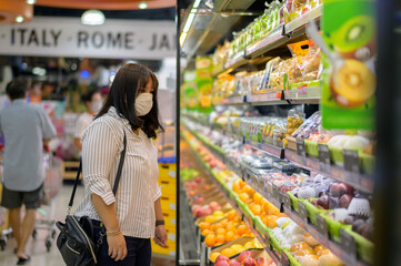 Asian Woman Wearing Mask Shopping in the Supermarket 