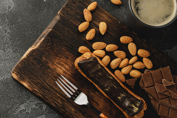 Eclair cake on dark wooden board on black table