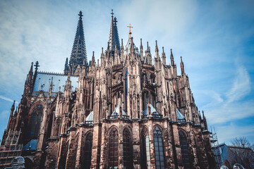 Fototapeta premium The stunning sculptured exterior of Cologne Cathedral, or also known as Kolner Dom, in the historic city of Cologne, Germany.