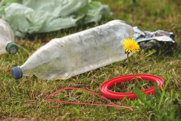 Saving the planet Earth nature and environment from pollution of plastic. dandelion sprout and...