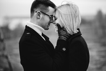 Stylish black and white love story. A loving couple looks at each other tenderly.