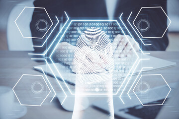 Blue fingerprint hologram over hands taking notes background. Concept of security. Double exposure