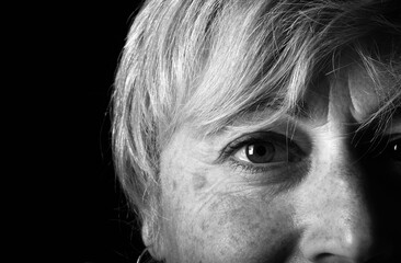 facial wrinkles of a fifty year old woman, black and white