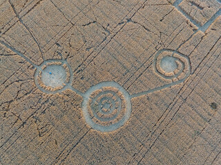 Mysterious crop circle in oat field near the city, aerial view