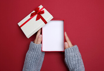 Holiday gift box opened.Hands holding present box top view.Product display.