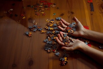 Girl's hand playing with a puzzle