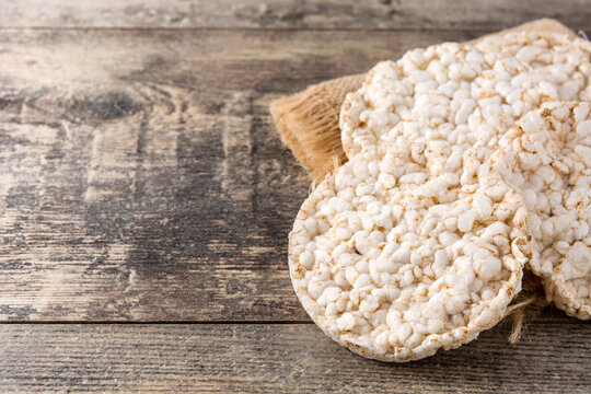 Puffed rice cakes on wooden table with copy space