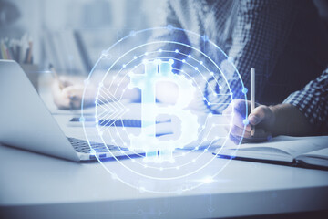 Blockchain theme hologram with man working on computer on background. Concept of crypto chain. Double exposure.