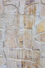 Textured surface of old stone weathered wall in the backyard