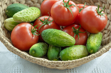 cucumbers and tomatoes in a wicker basket