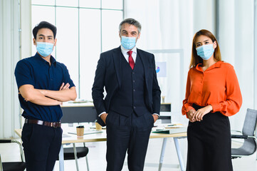 Fototapeta premium Business office people maintain social distancing meeting room. Stop covid-19 coronavirus. New normal lifestyle in job.