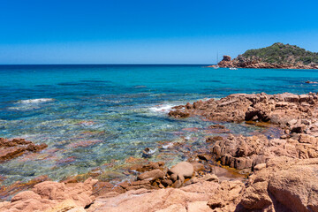 Fototapeta na wymiar landscape, red rock above a blue bay in the beach of Su Sirboni