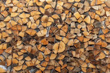 Large woodpile with firewood. Background, texture. Space for text.