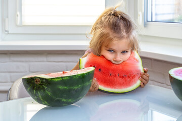little blonde girl eating a piece of watermelon