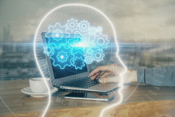 Businessman with computer background with brain theme hologram. Concept of brainstorm. Multi exposure.