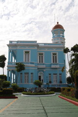 Naklejka premium Beautiful isolated close-up of a blue palace in Cienfuegos, under a cloudy blue sky, Cienfuegos, Cuba. 