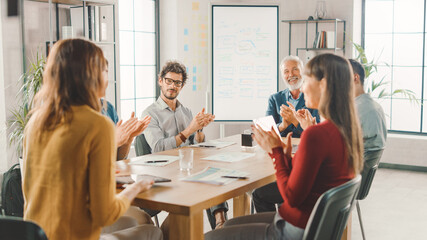 In the Meeting Room Young Female Make a Presentation to a Company's Specialists, Managers and CEO. They are Clapping in a Support of her Brilliant Idea. Office of Modern Startup