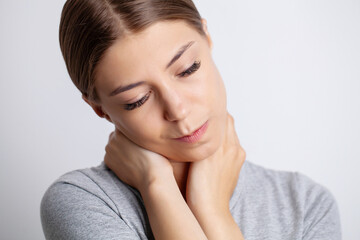 Young woman is experiencing severe neck pain