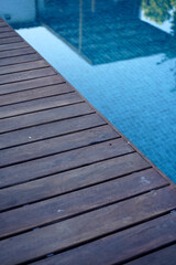 Blue swimming pool with wooden 