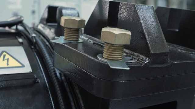 Electric motor on plant, close-up of fastening elements