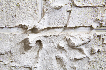White hand made brick wall background, Abstract pattern with inequalities, Close up view to light gray brick texture. 