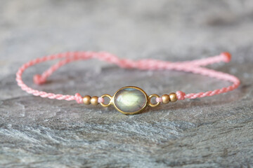 Elegant labradorite stone bracelet on rocky background