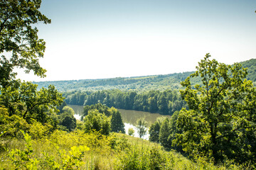 Beautiful summer landscape of green nature. Forest, river and hills