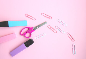 School stationery and supplies on a pink background with space for caption. Back to school, homeschool creative workspace. Minimalistic set of colorful stationery. Flat lay