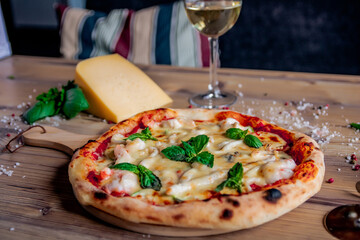Appetizing pizza served on a service plate on a decorated table