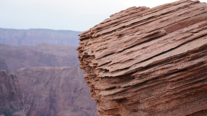 Horseshoe Bend rock formation with steep cliffs rising up from Colorado River in Page, Arizona, USA.