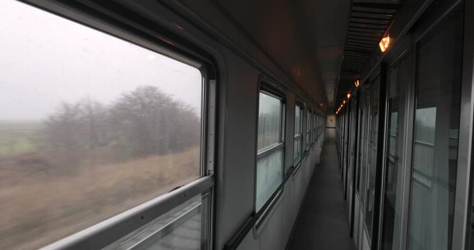 Interior of a passenger train with empty corridor and cabins, train trip