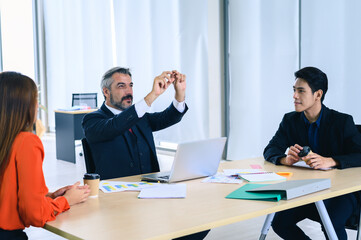 Business, technology, internet and network concept. A group of people works with a hologram on the screen 