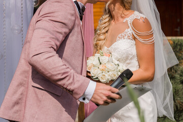 groom with microphone at wedding ceremony