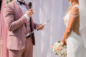 groom with microphone at wedding ceremony