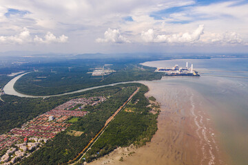 Fototapeta na wymiar An aerial view of the dock of a Coal Power Plant at the Malaysia west coast. Two coal cargo ship at the dock to supply coal to the plant. At the polluted west coast of strait of Malacca. 