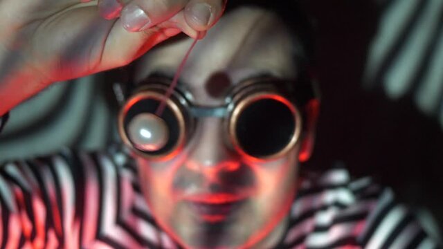 A strange character trying to hypnotize the viewer with a pendant going sideways. Steampunk concept