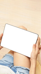 Obraz premium Home office. Young girl holding tablet with white screen. Mock up. Perfect for application. Bussiness women. Laptop gadget. Sitting child learn trendy technology