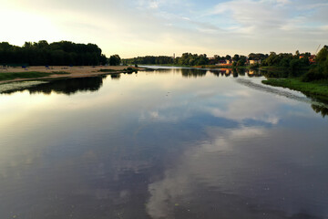 river with reflective trees and clouds at dawn filmed from a dronedefault