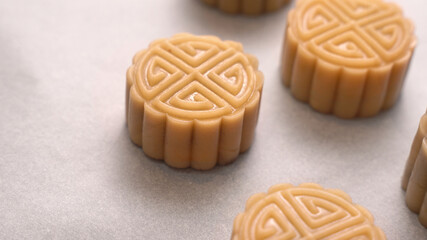 Homemade cantonese moon cake pastry on baking tray before baking for traditional festival, close up, lifestyle.