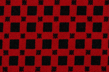 Red cotton fabric with squares pattern texture background.