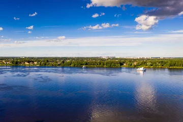 Foto op Canvas a panoramic view of the big blue river and the ships sailing along it filmed from a drone © константин константи